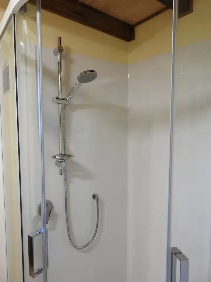 A clean, modern walk-in glass shower