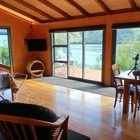 A bright, airy bedroom with twin chairs and clerestory windows