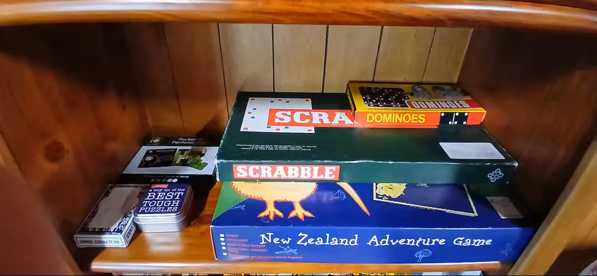 A shelf of board games for slow evenings in