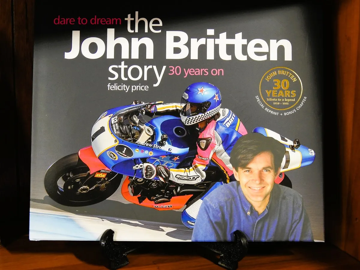 A book on John Britten, the legendary New Zealand motorcycle engineer, beside a model of his bike