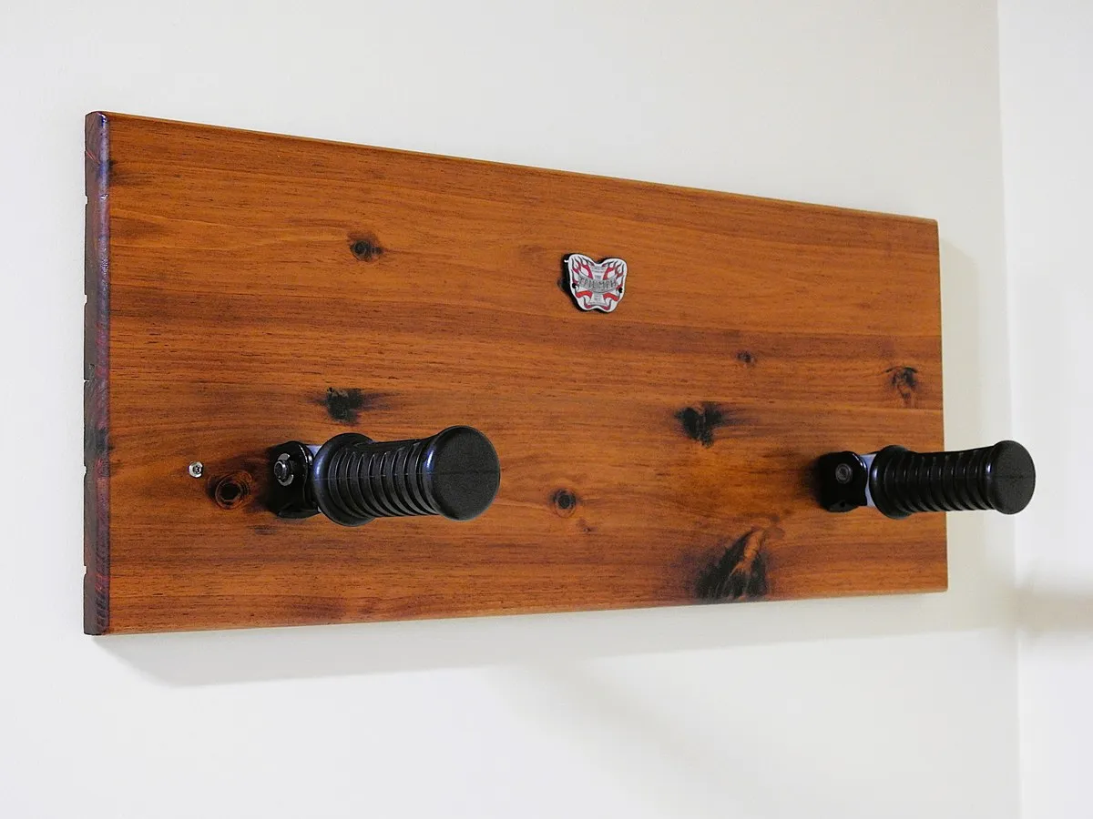 Chromed motorcycle foot-pegs repurposed as robe hooks on the cabin wall